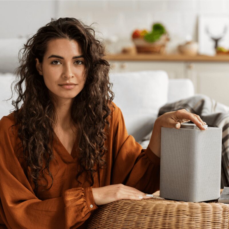 woman showcasing an indoor air purifier